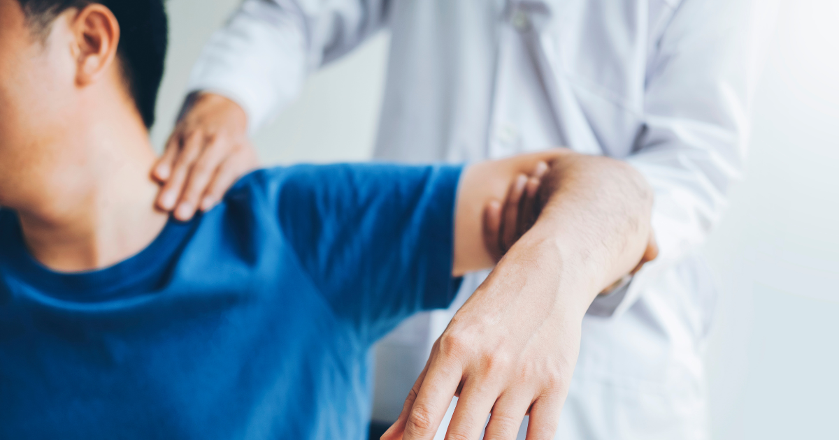 Physician at OC Wellness examines a personal injury patient's shoulder as part of multi-specialty care delivered under a medical lien.