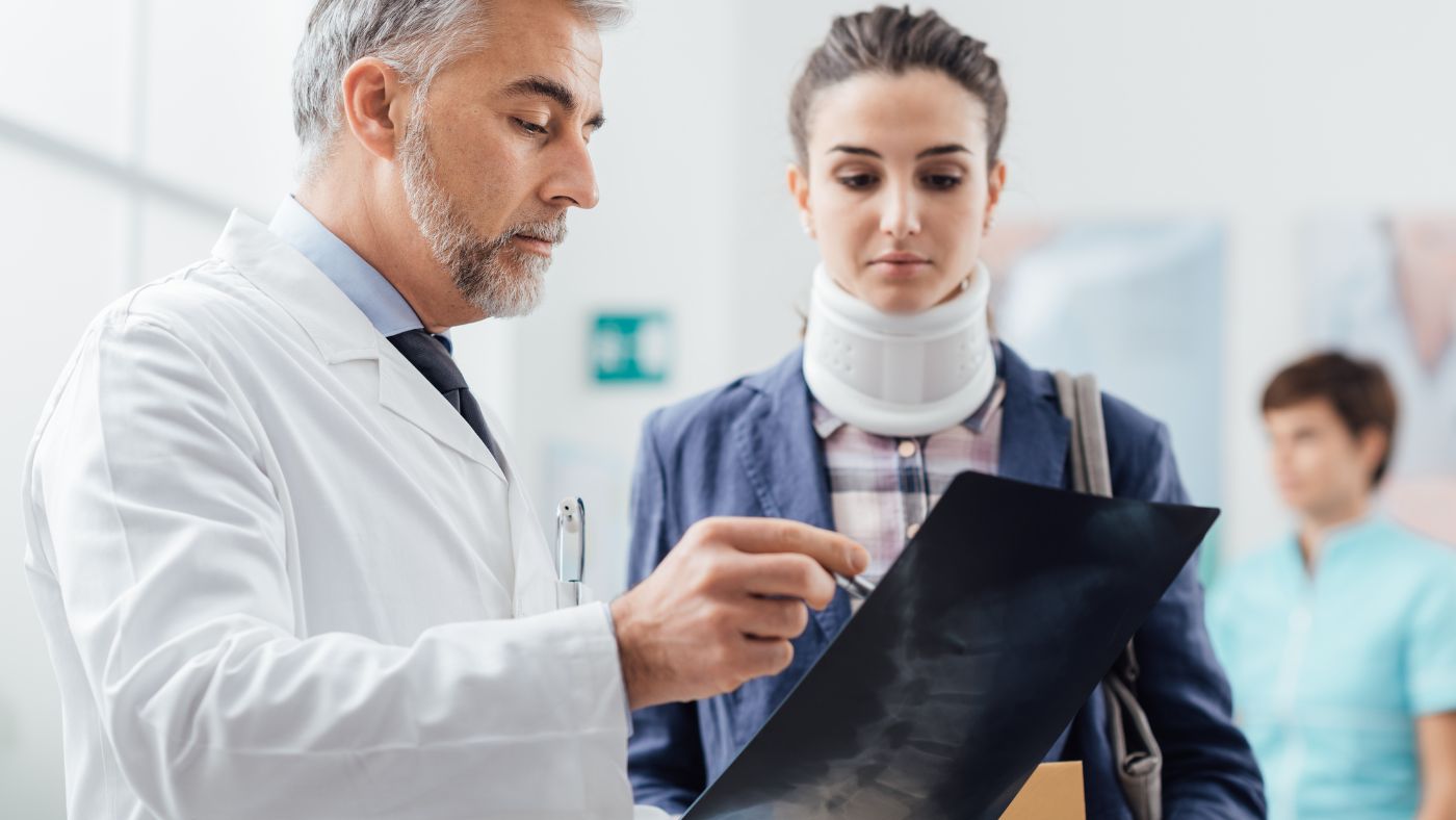 Physician reviewing a neck x-ray with a patient during a cervical PRP consultation at OC Wellness Physicians Medical Group