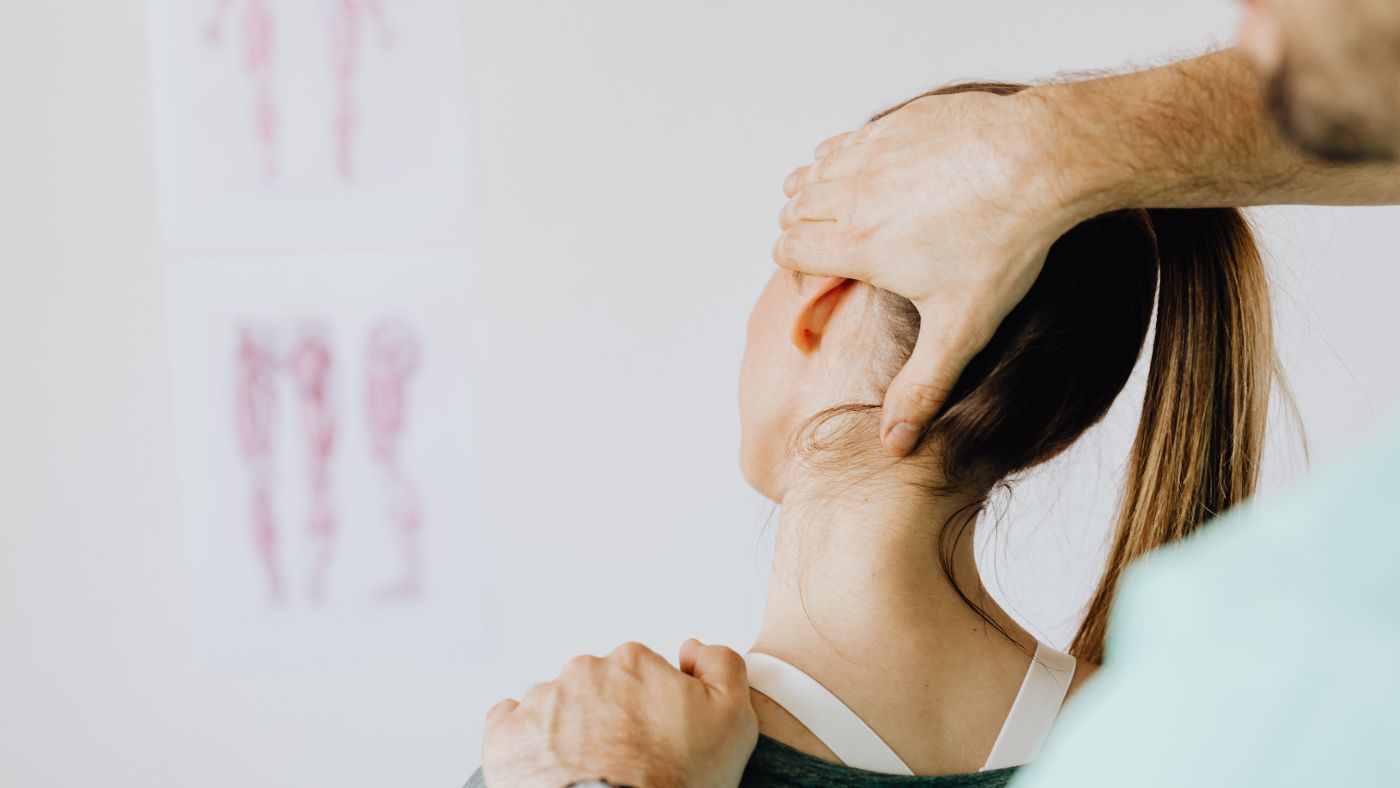 Chiropractor treating a patient's neck for whiplash after a car accident
