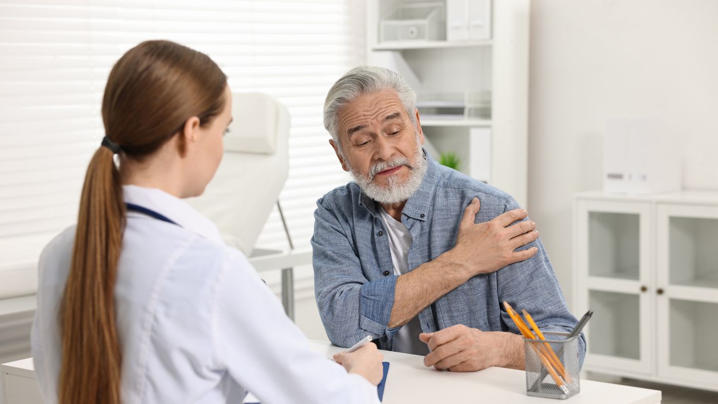 Physician evaluating a patient's shoulder for PRP and stem cell therapy at OC Wellness Physicians Medical Group