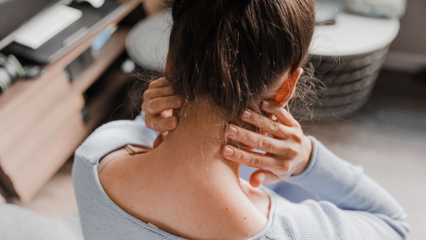 Woman holding her neck in pain after a car accident in Orange County