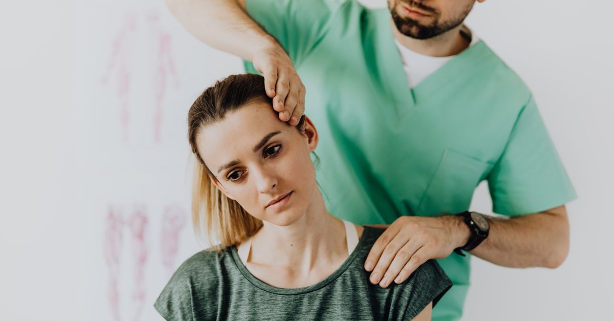 Physician examining a patient's neck to determine whether neck pain is causing headaches.