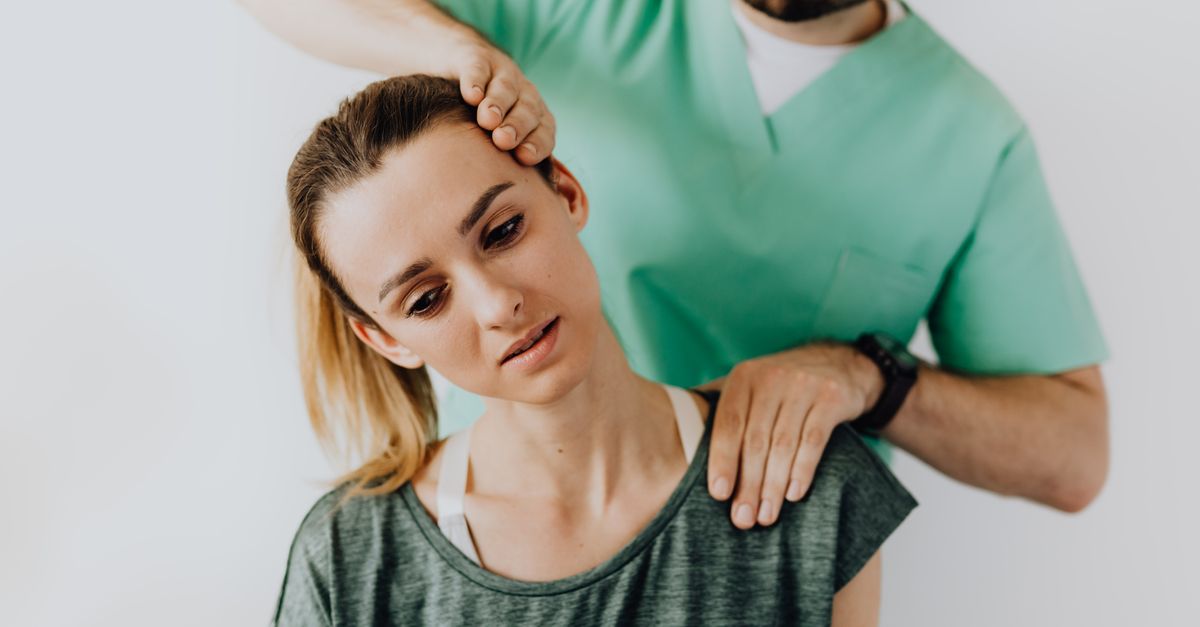 Therapist treating a patient's neck muscles to relieve neck pain that can cause headaches.
